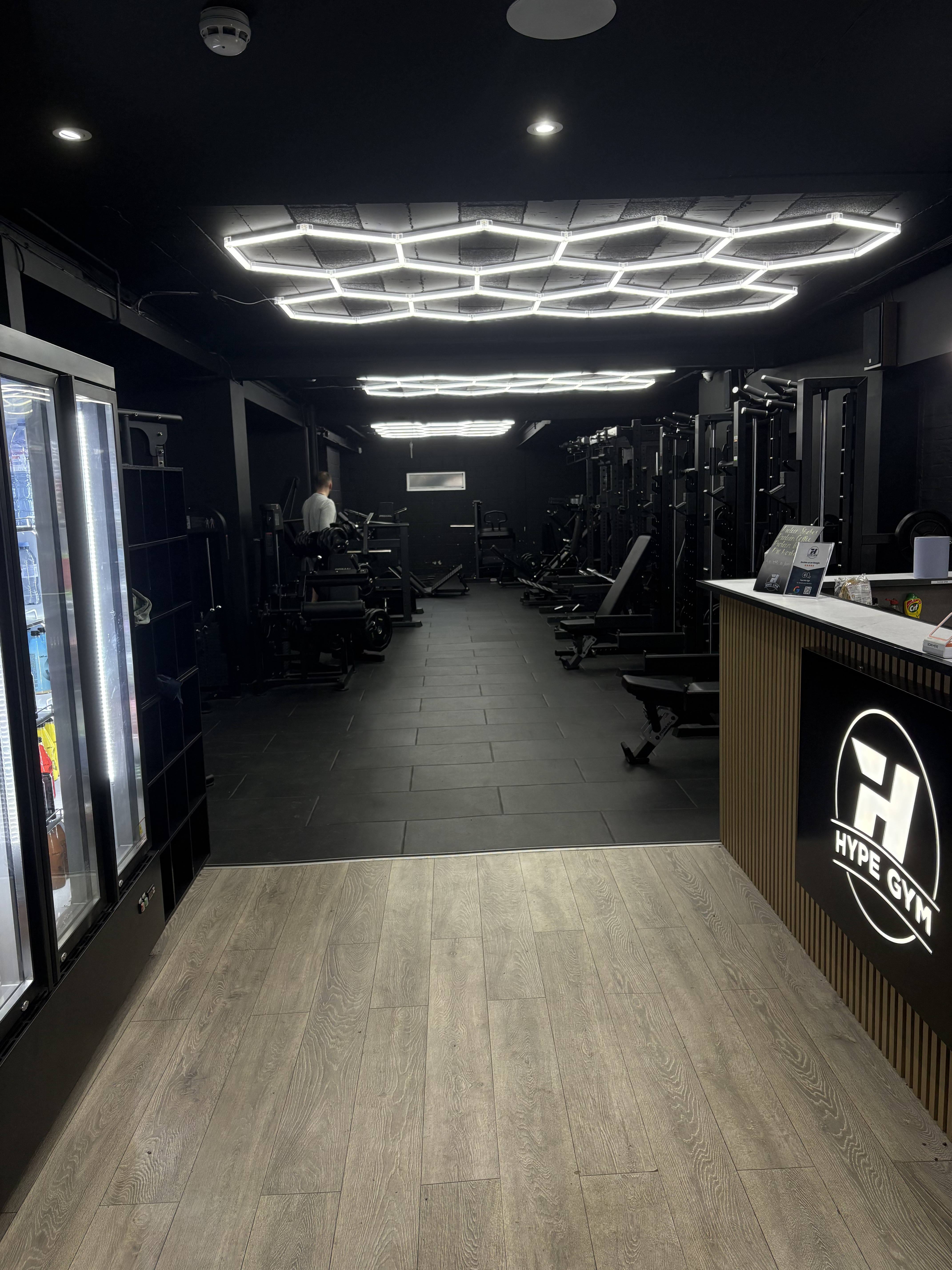 Hype Gym floor with strength machines under hexagonal LED lights