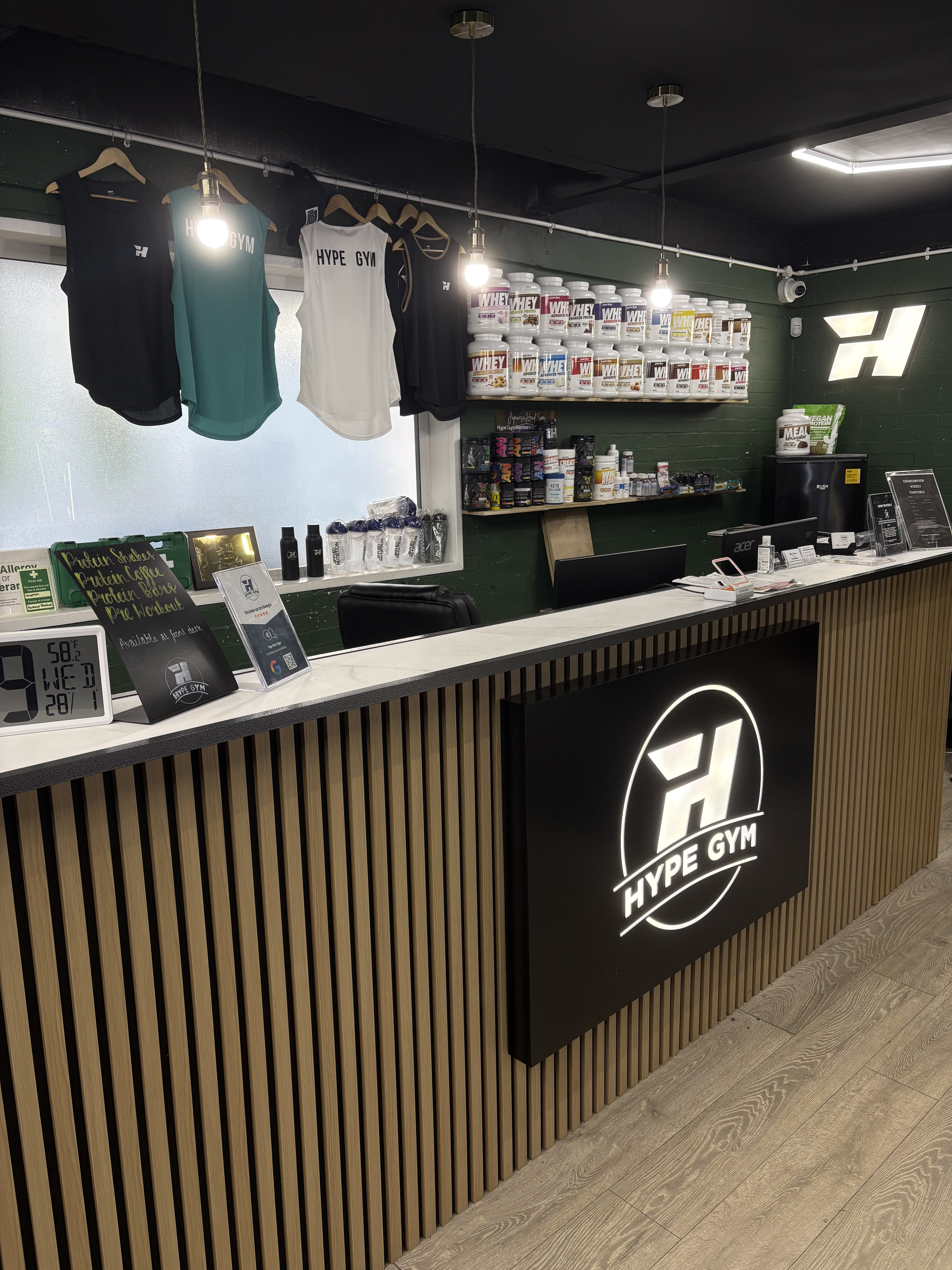 Reception desk and supplement bar with Hype Gym logo